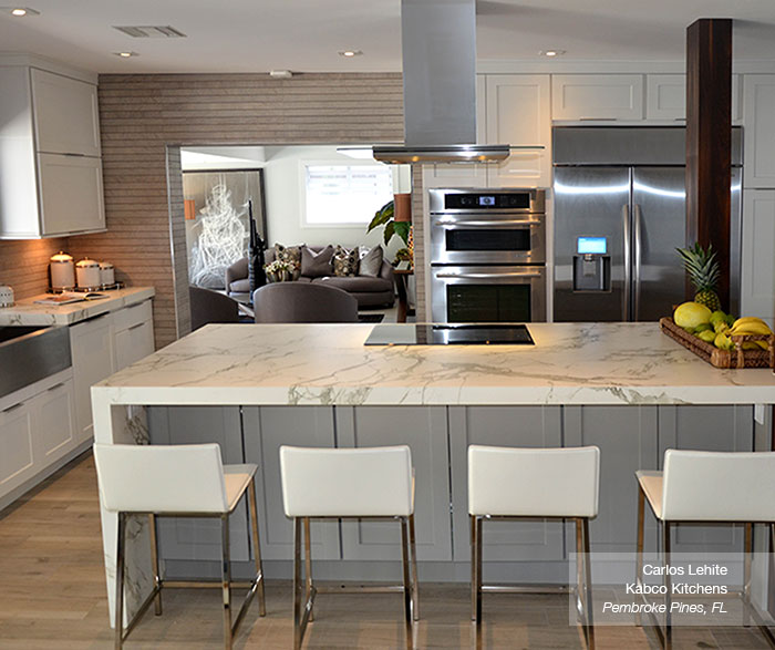 white cabinets in the dover door style with a gray kitchen island